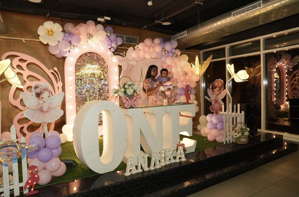 Mother and baby celebrating on lighted fairy stage with butterfly wings