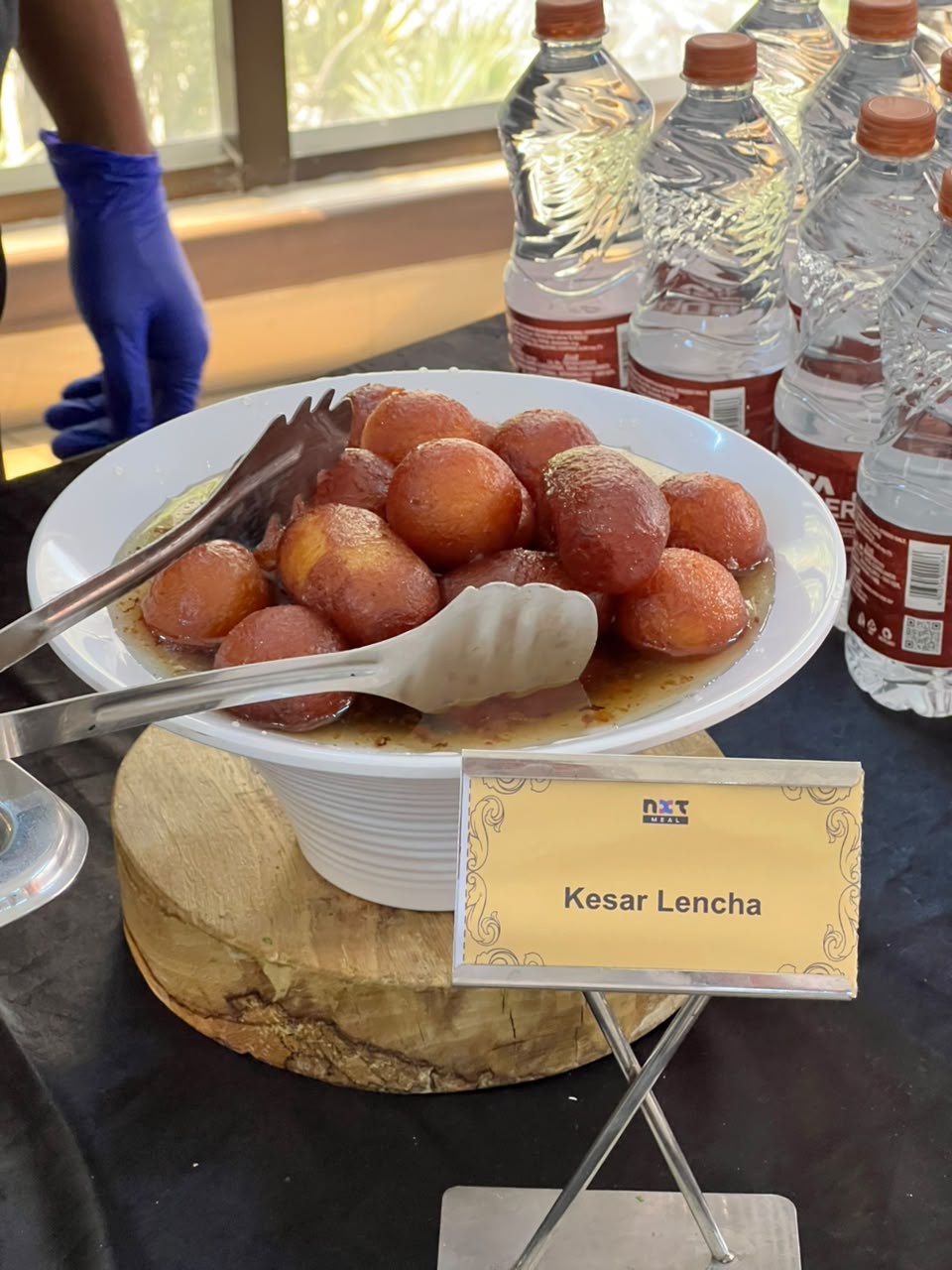 Live dessert station featuring golden Kesar Lencha sweet bowl display