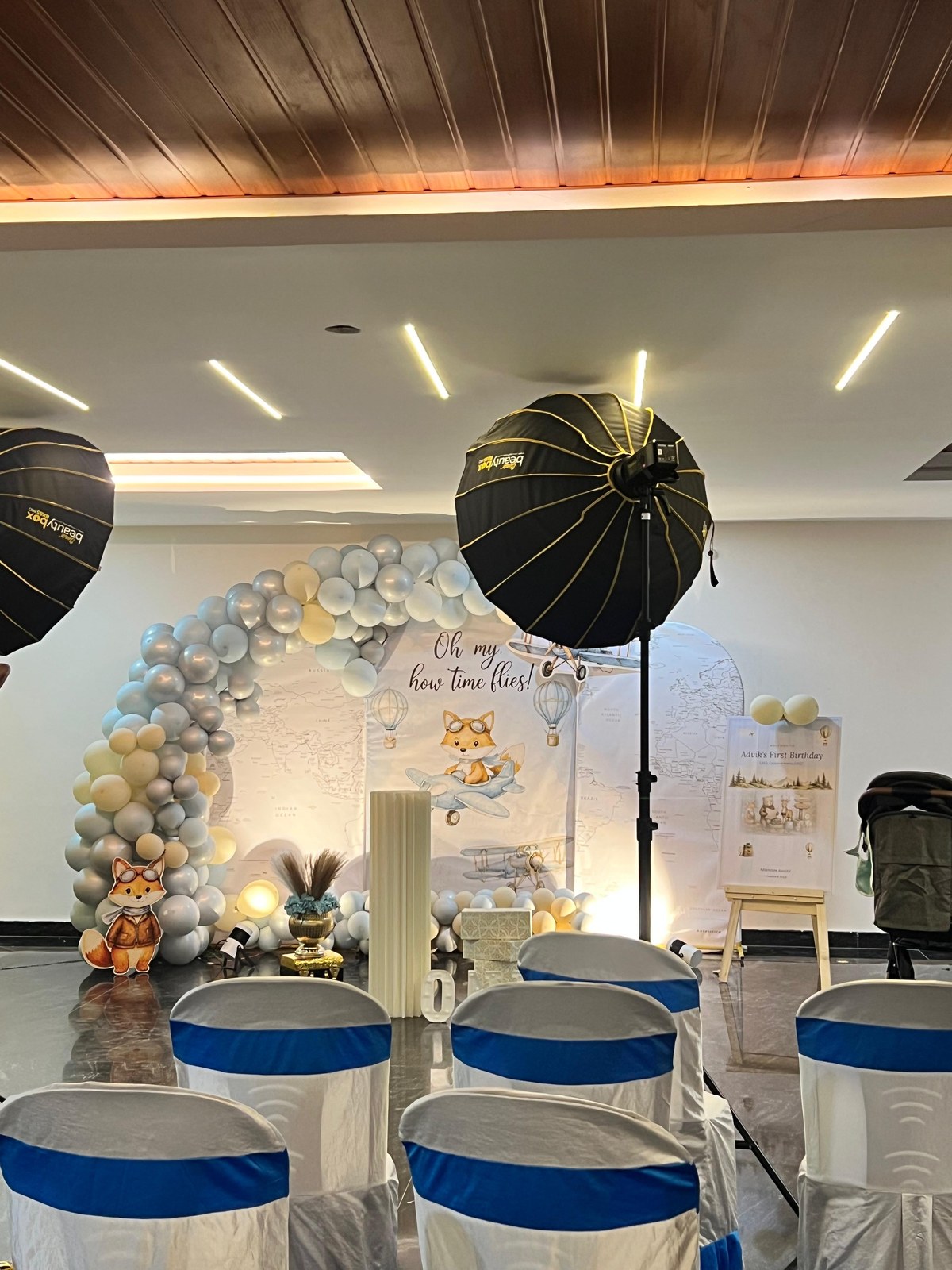 Advik's First Birthday Aviator Time Flies balloon arch and stage backdrop